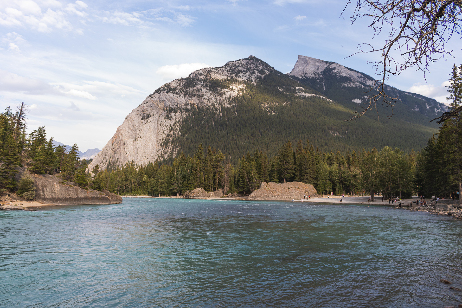 Photograph of a river with a rocky mountain behind it.